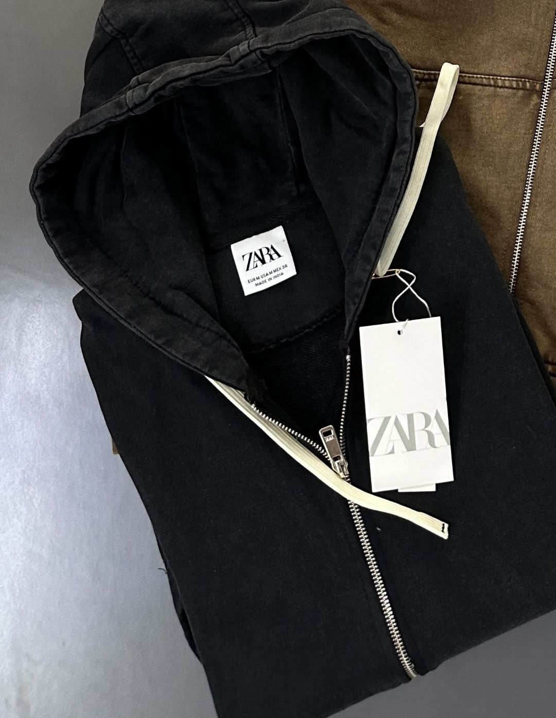 Washed black zip hoodie with cream drawcords